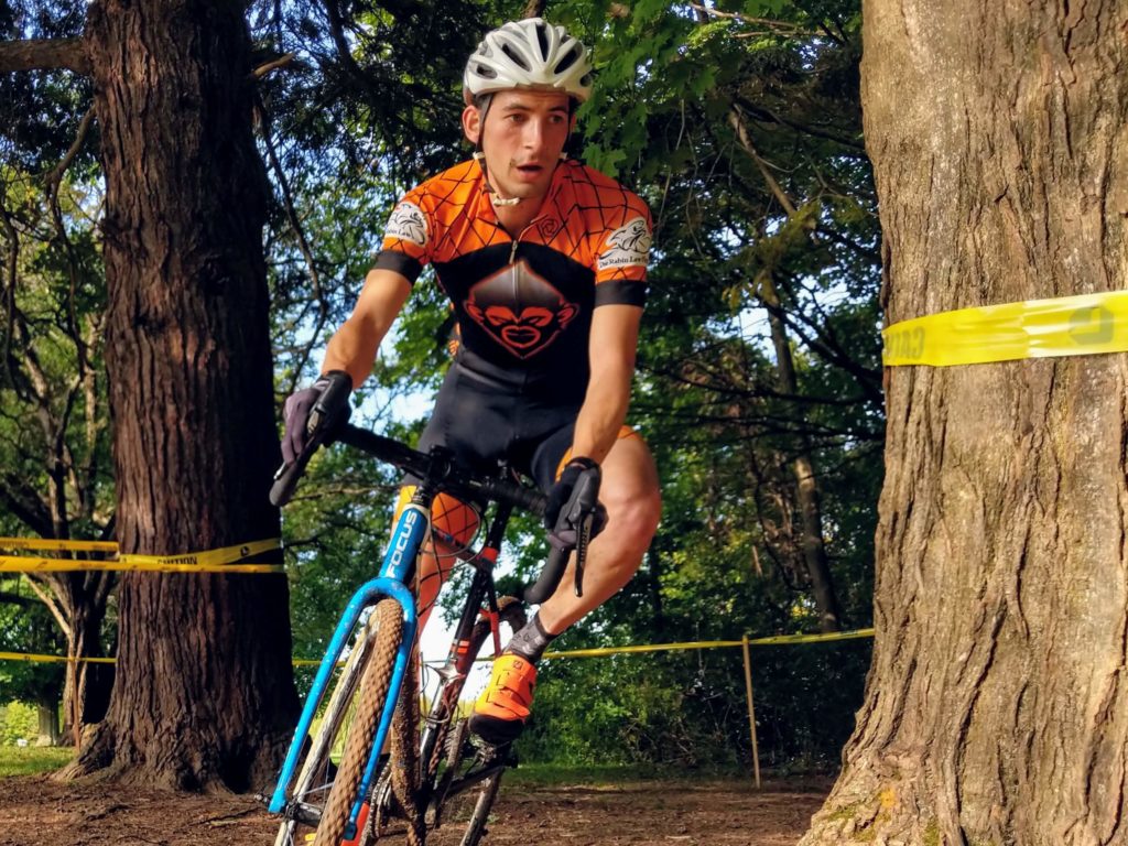 Jon Cyganik corners around a tree on his cyclocross bike